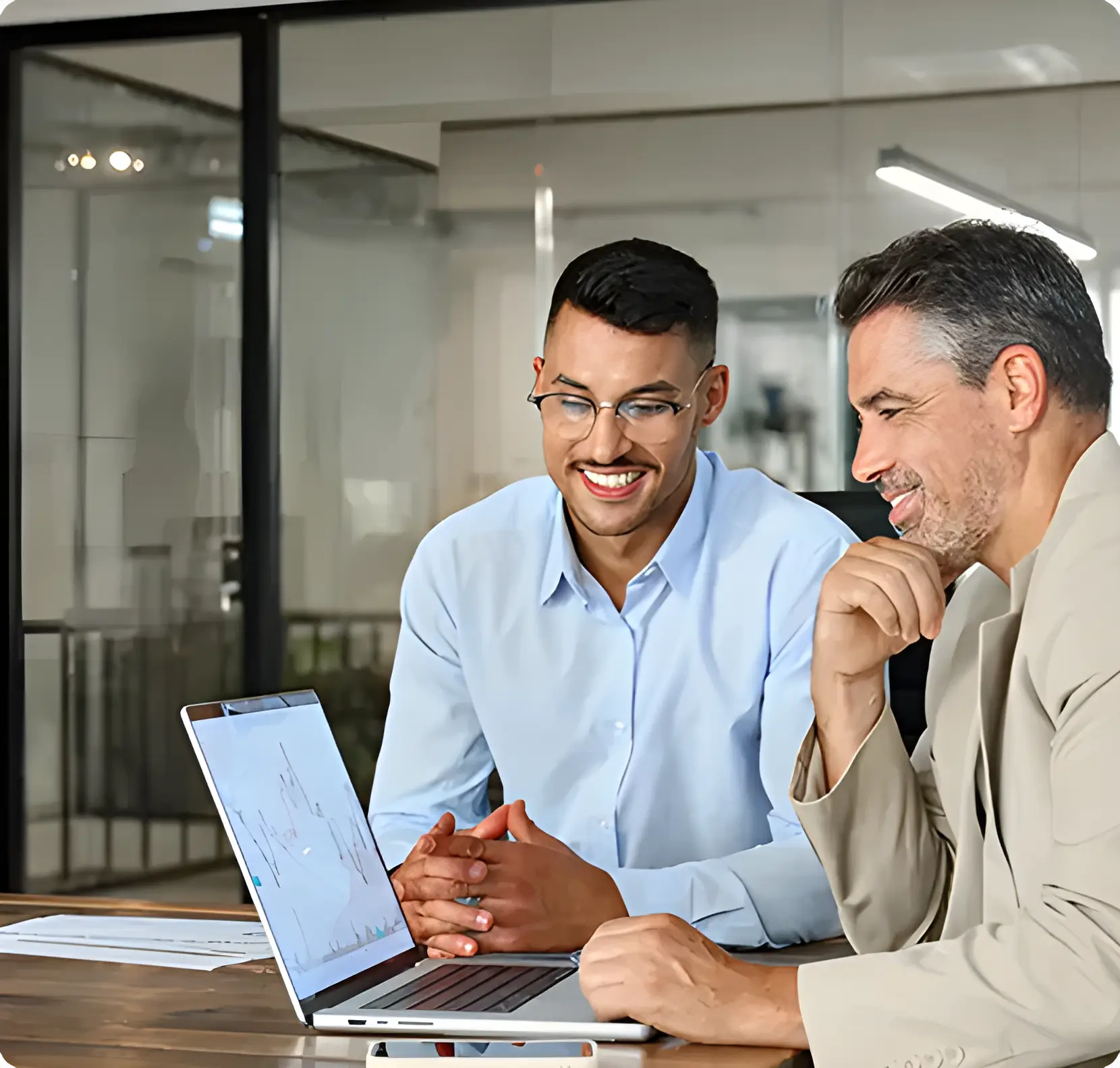 Financing advisors reviewing business performance on a laptop with a client